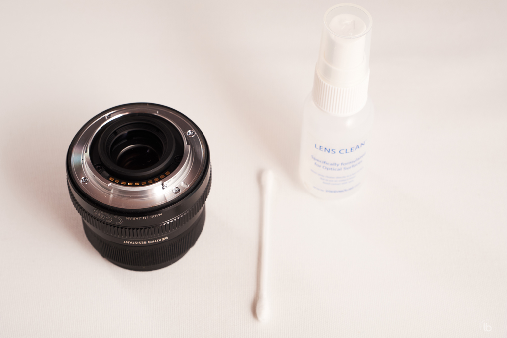Q-tip moisted with lens cleaning solution use to clean the lens mount.